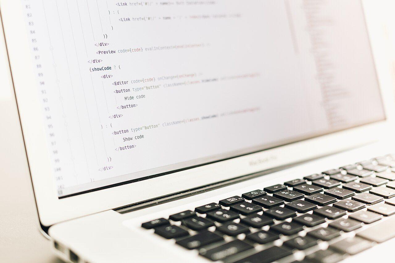Close-up of colourful lines of code on a laptop screen