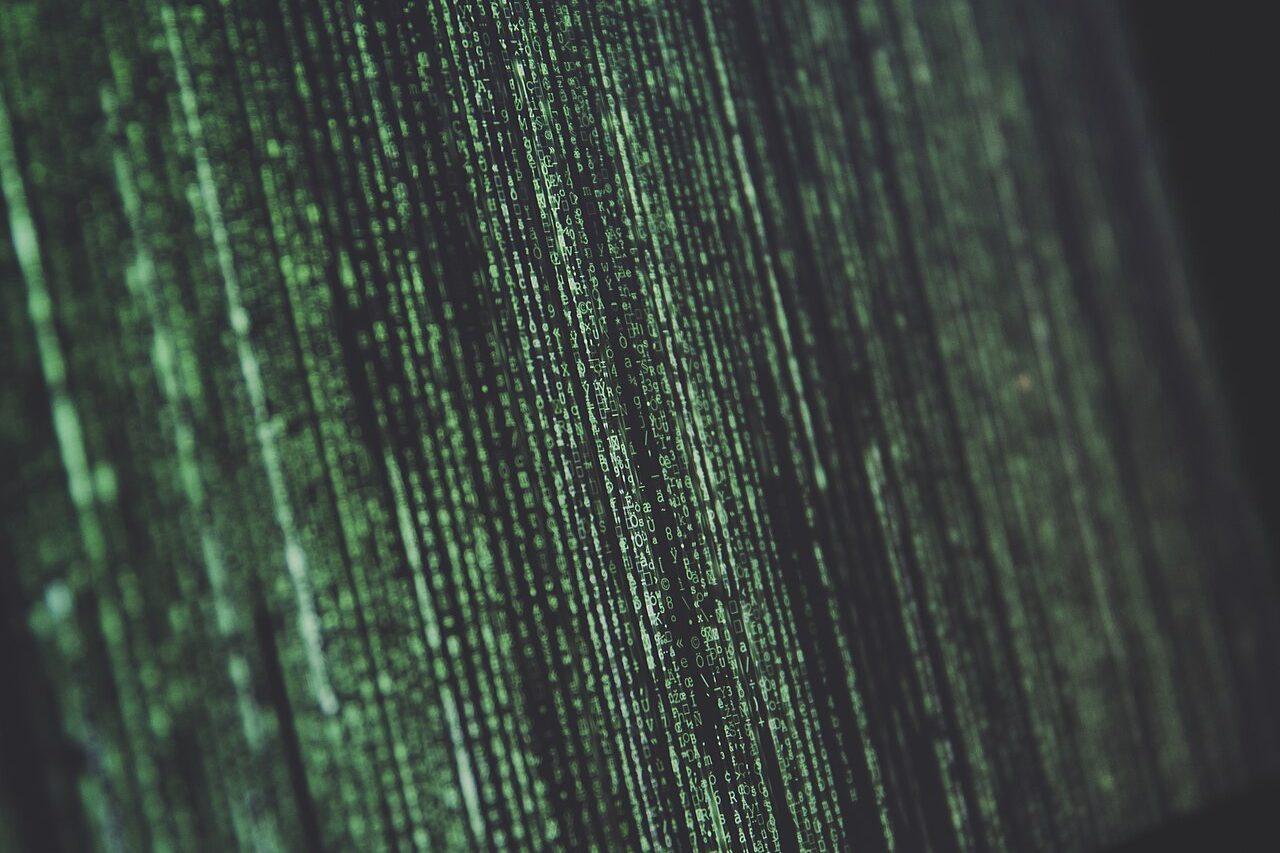 Green cascading code on a dark laptop screen